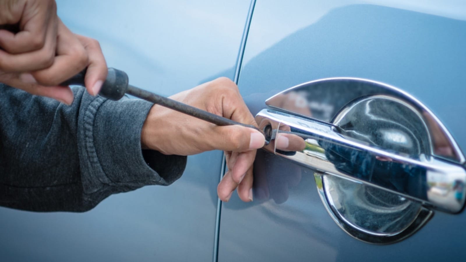 Thief breaking into car