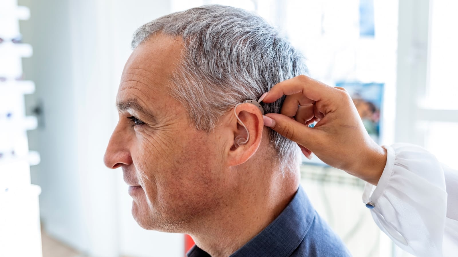 hearing aids senior man trying on a hearing aid