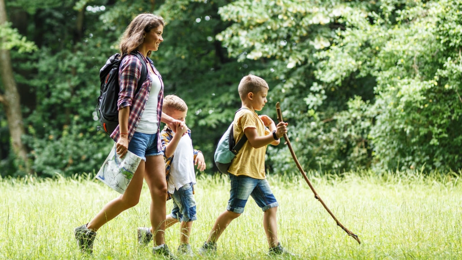 mother and two sons walking outside