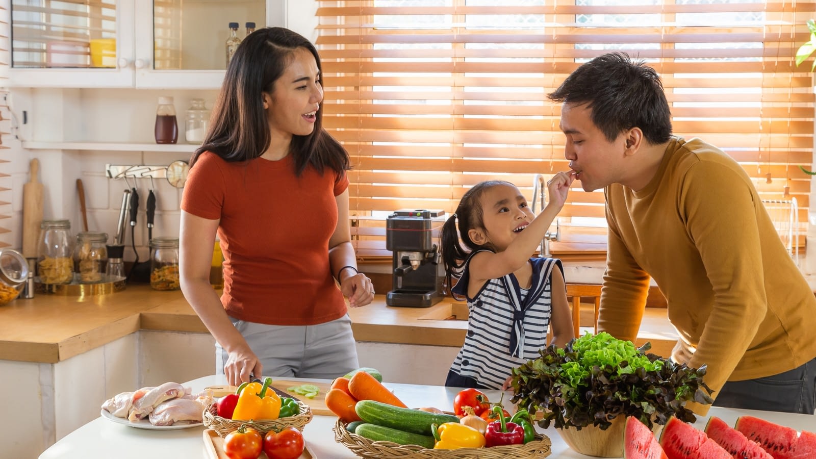 Family of three eating healthy foods