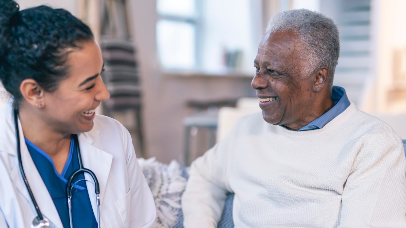 senior man speaking with healthcare professional