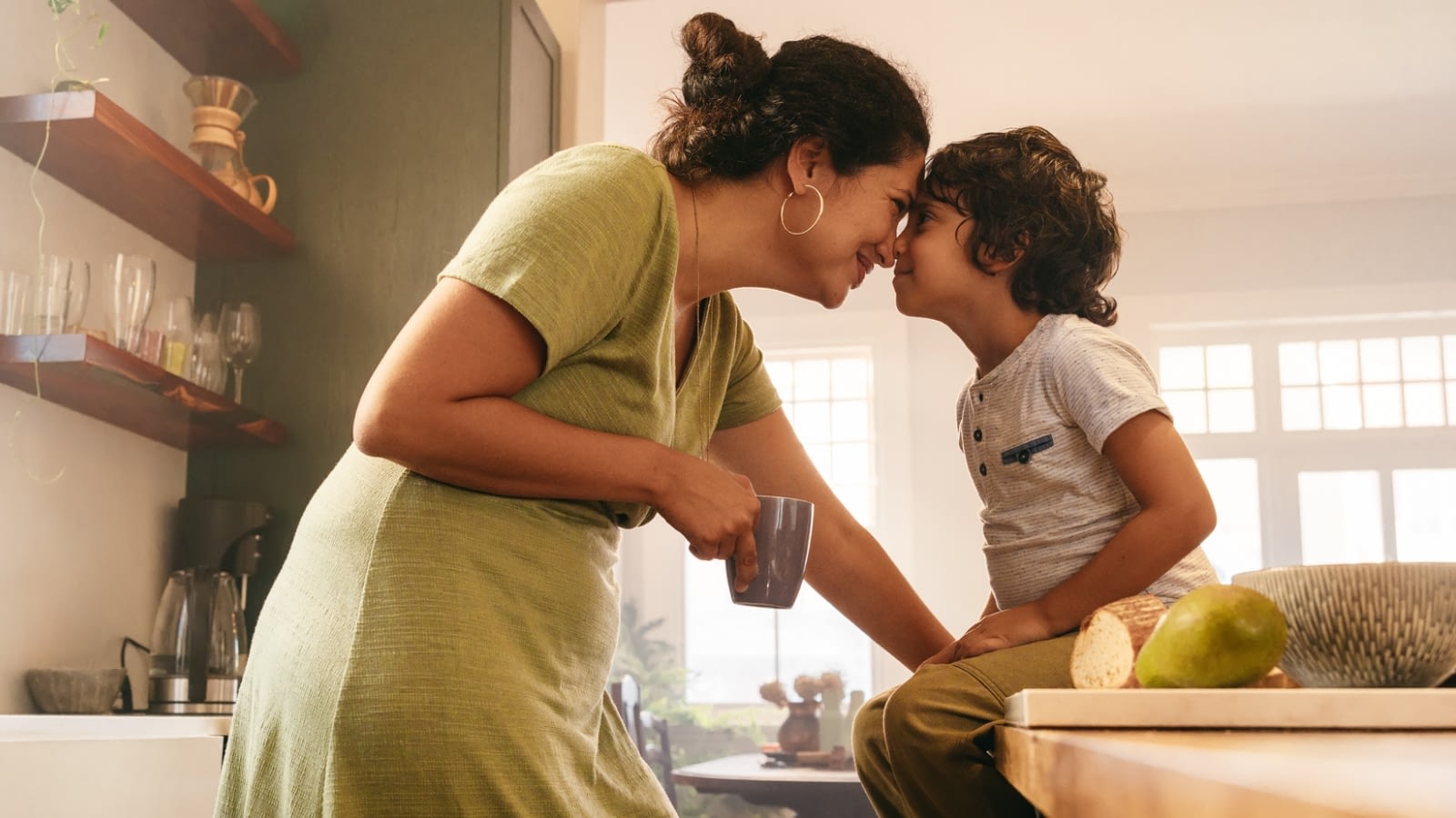 mom and son touching faces and smiling in the kitchen