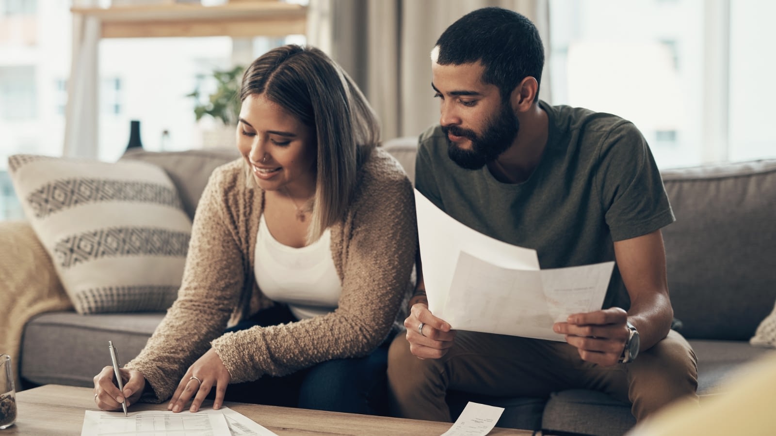 couple reviewing insurance documents together on a couch