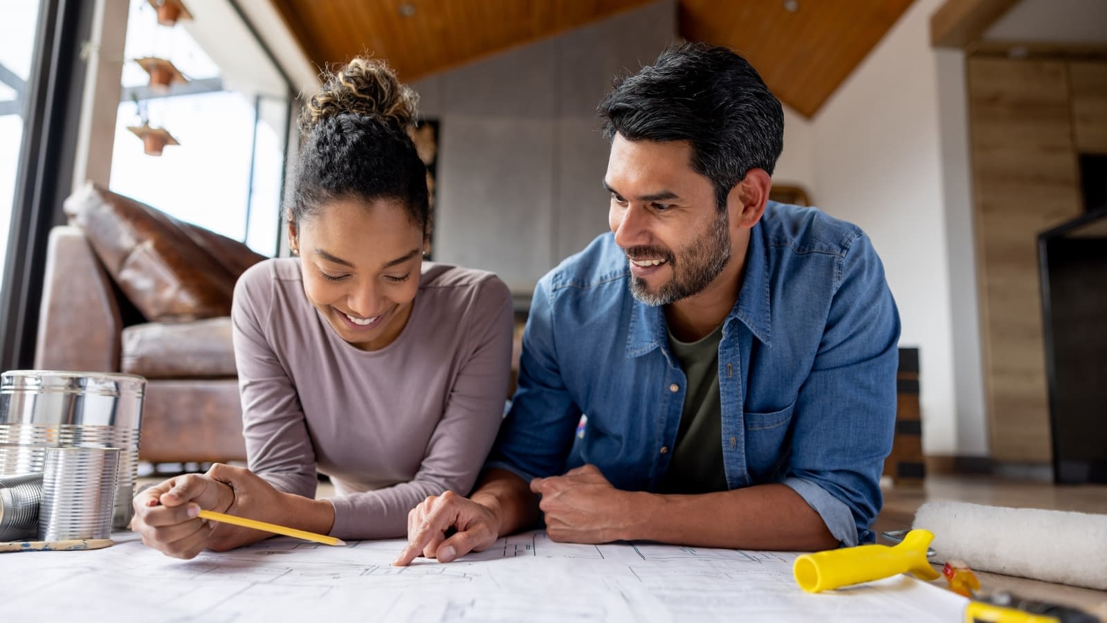 April 1 blog Young couple looking at home remodel plan.