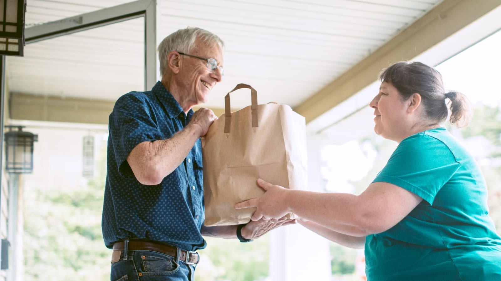 senior man having a meal delivered to his house