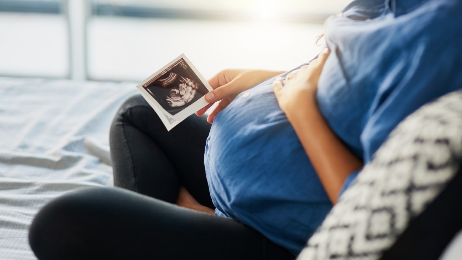 pregnant woman holding an ultrasound