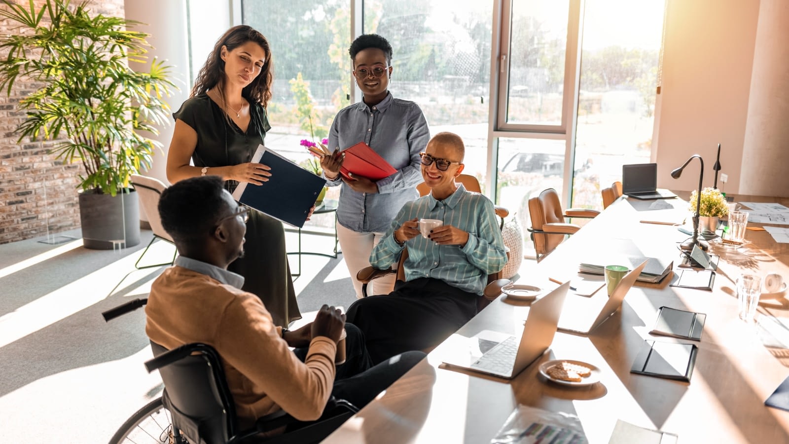 group of diverse employees at office, one in wheelchair.