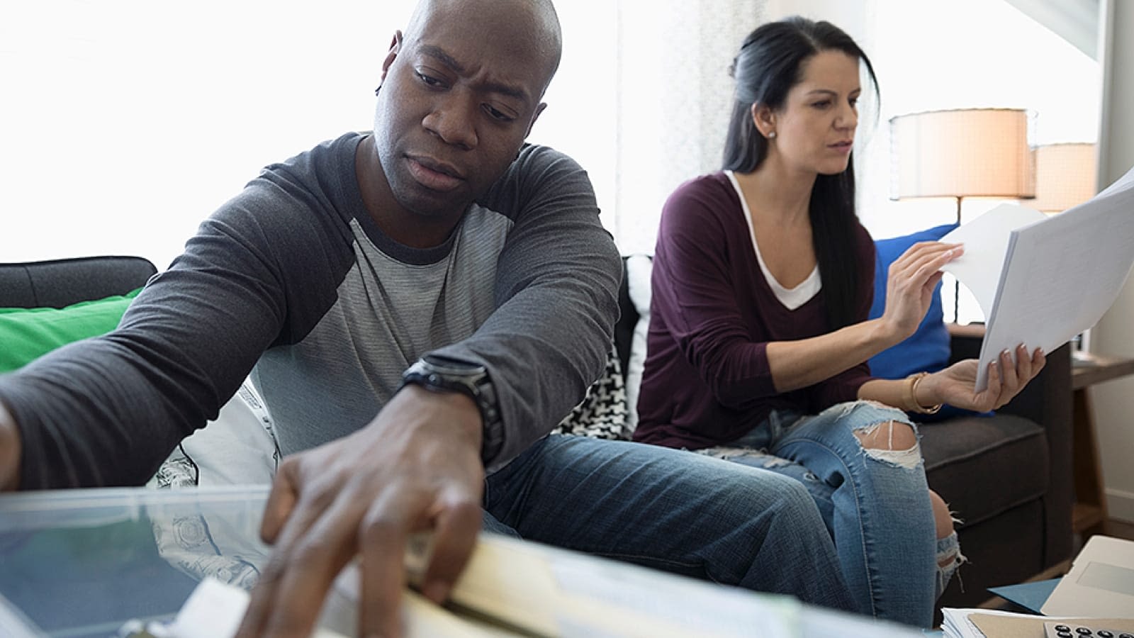 lostpolicy_large Couple looking through paperwork to find a lost life insurance policy