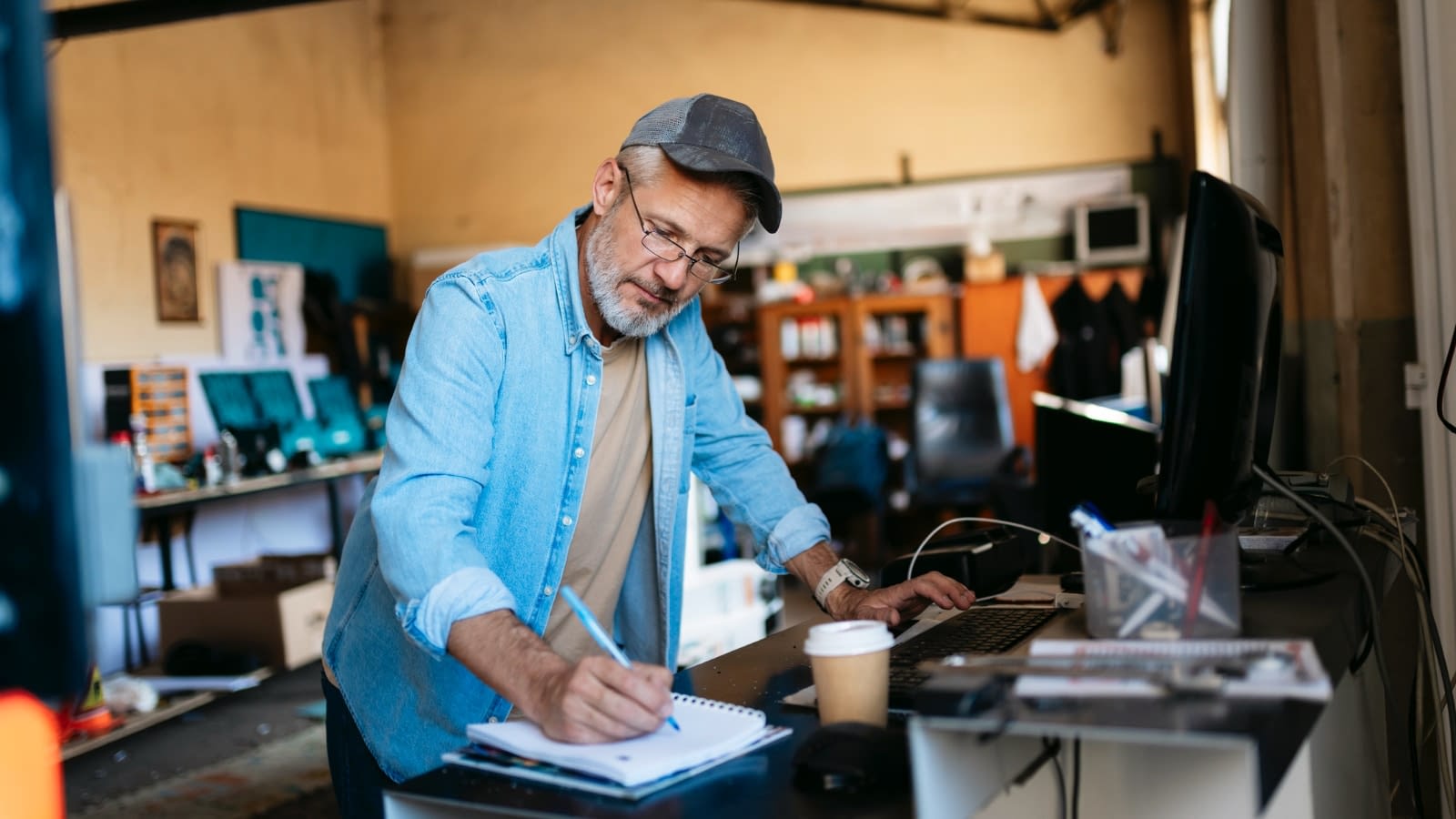 Dec 19 blog Older male business owner doing paperwork in his shop