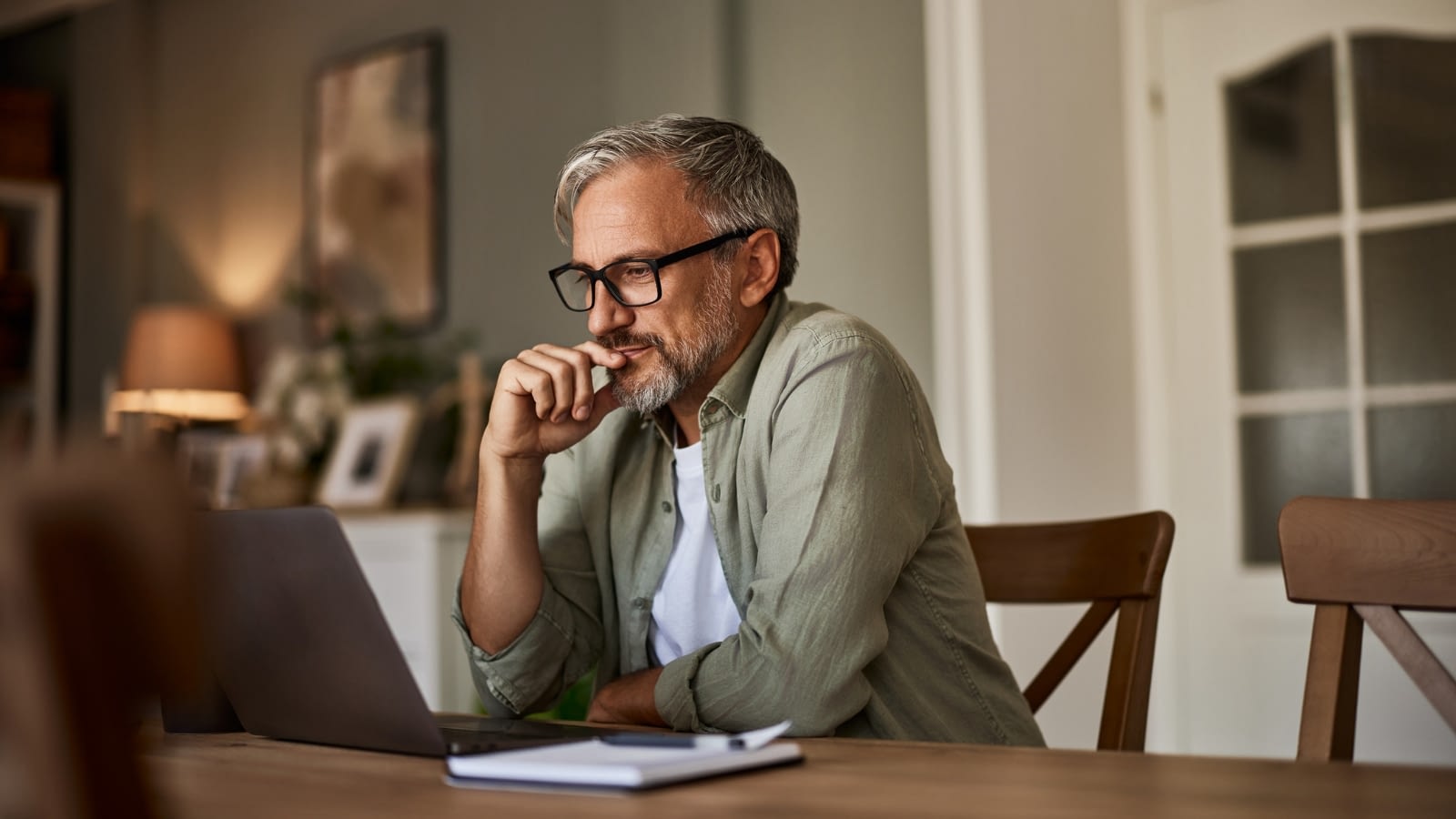 man reading on his laptop
