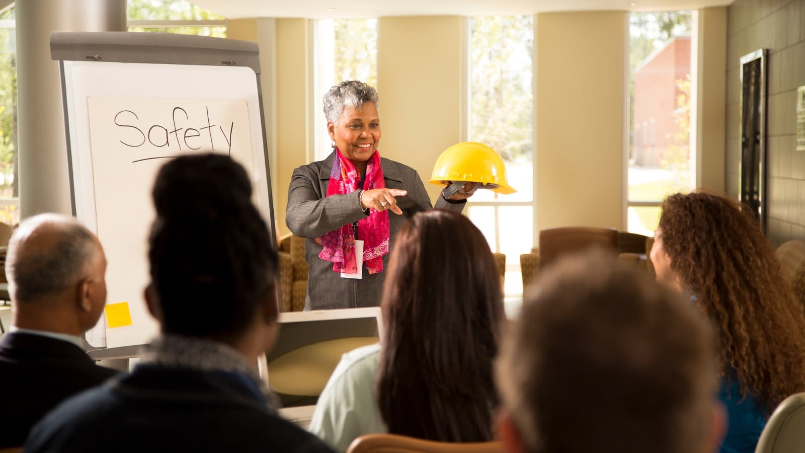Business safety meeting Woman presenting at safety meeting