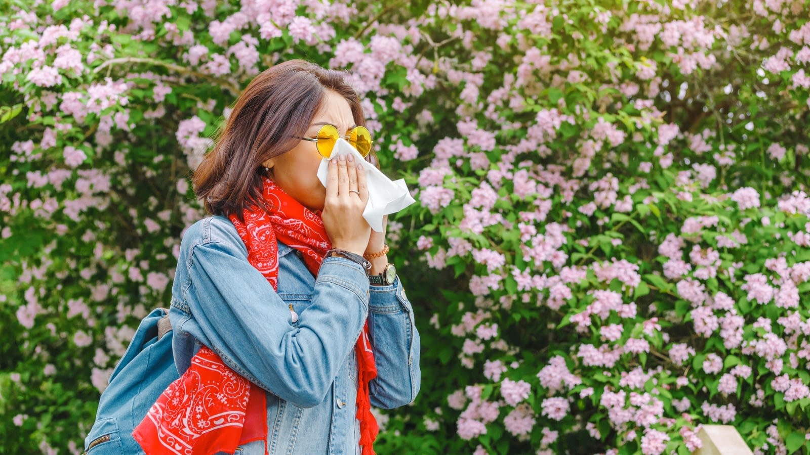 April 25 blog Young woman sneezing due to spring allergies