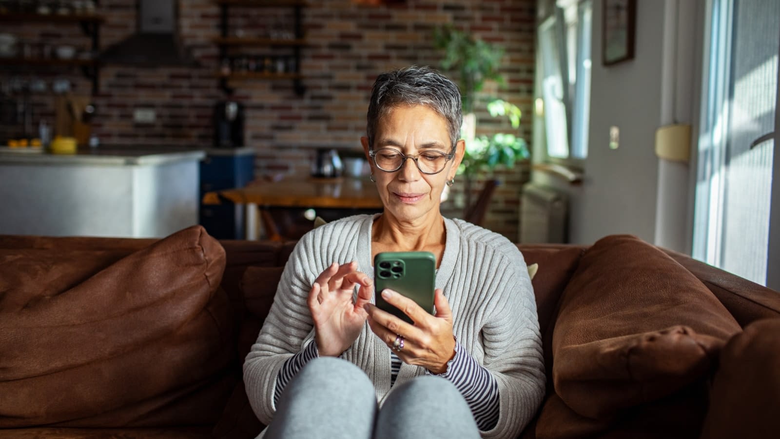 June 21 blog Female senior citizen reading something on her phone about Medicare.