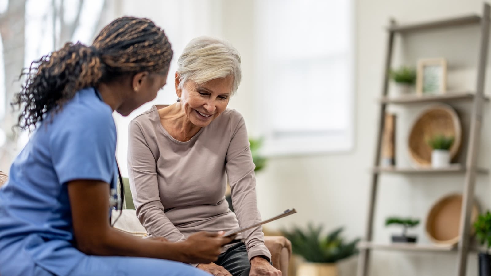 June 6 blog Young doctor speaking with her elderly female patient.