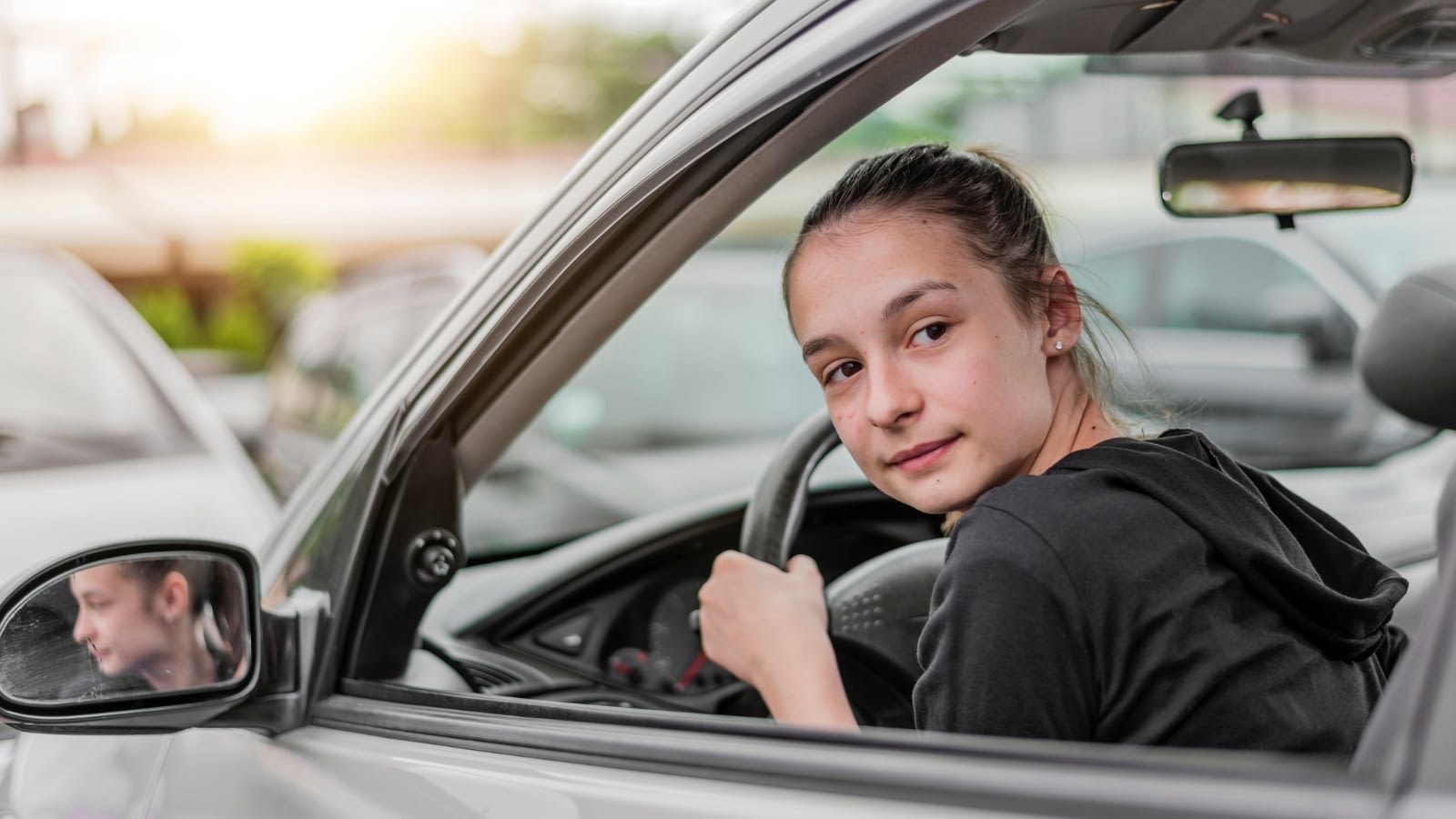 teenage girl driving a car