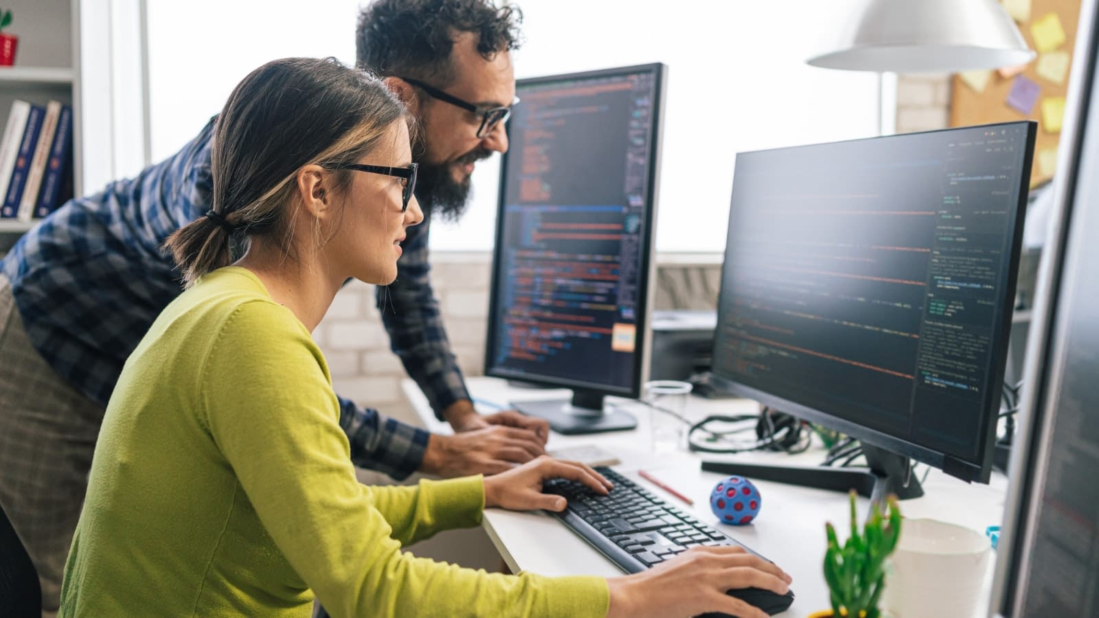 July 4 blog Female and male co-wokers looking at cyber security on computer