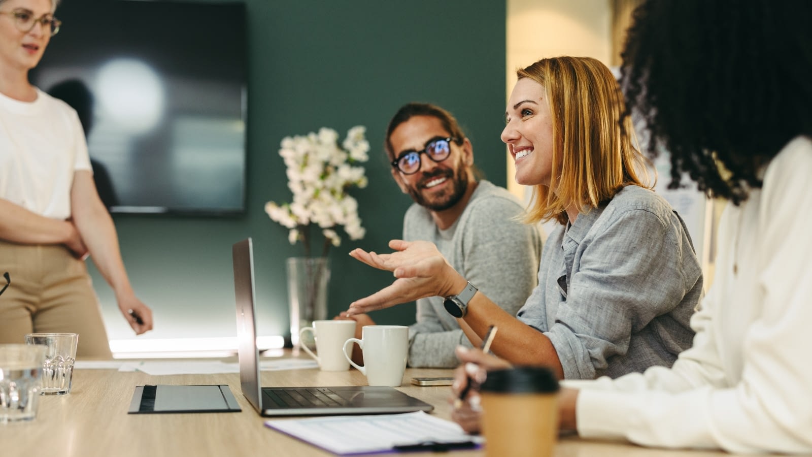 Group of employees cheerfully engaged in a meeting