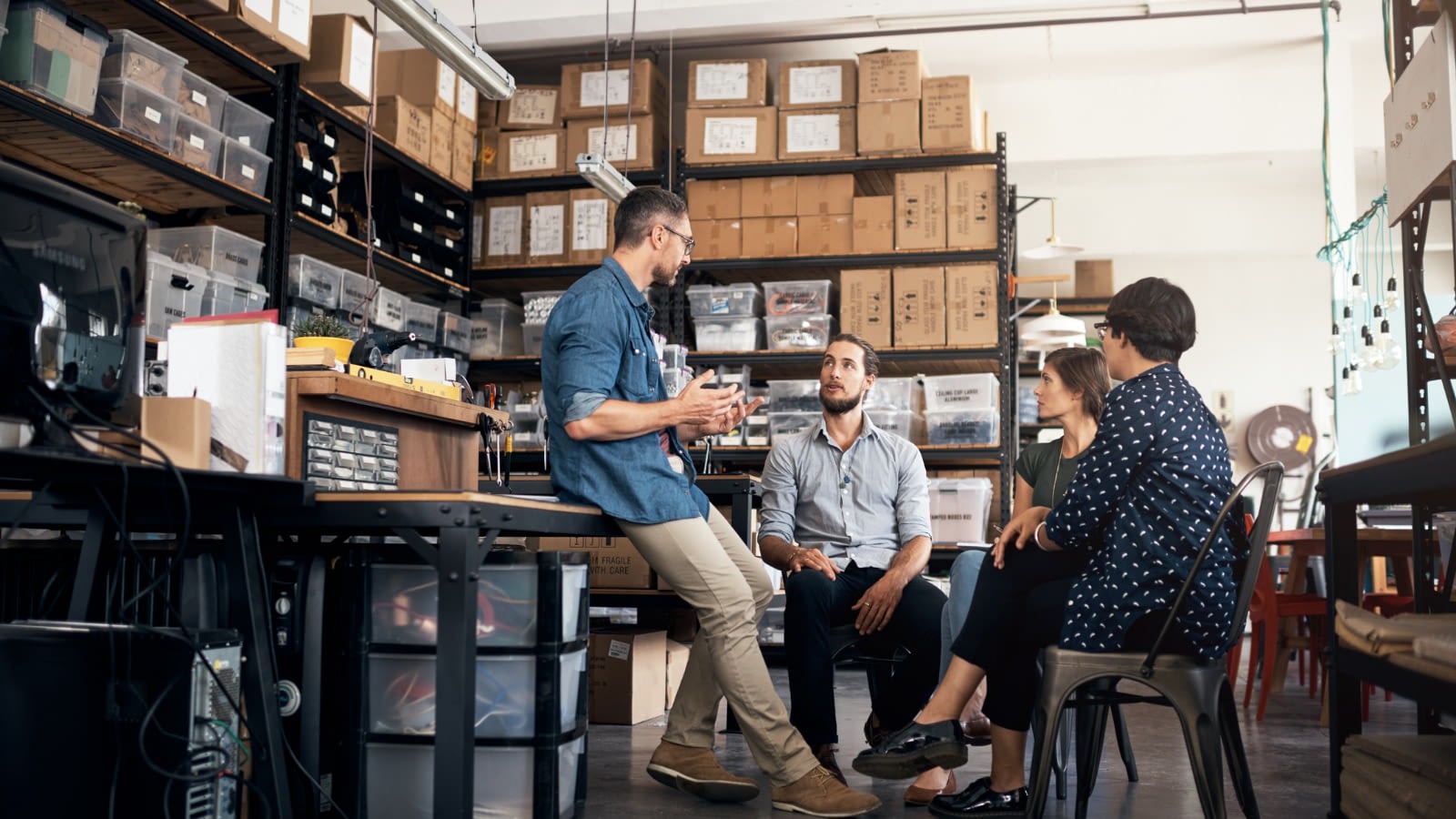 Group of staff having a warehouse meeting.