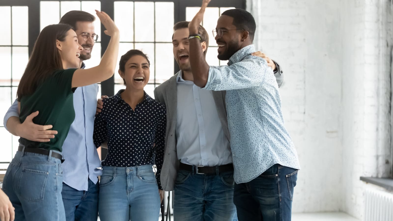 3 Things to Consider When Choosing Group Benefits Employees giving each other five