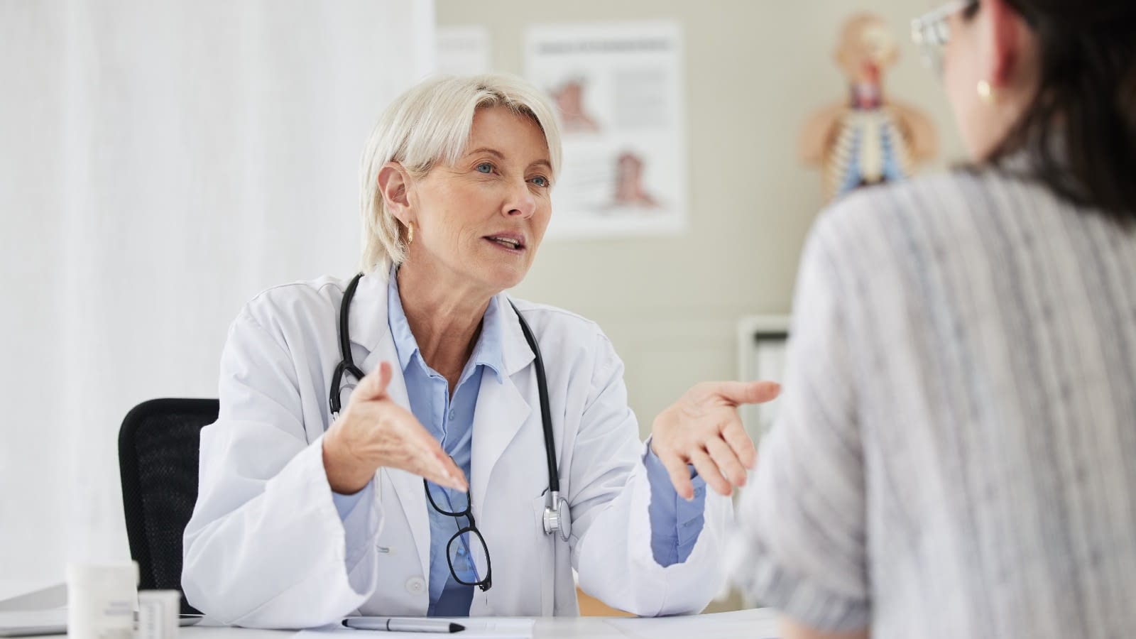 Doctor and patient in the office Doctor speaking to patient