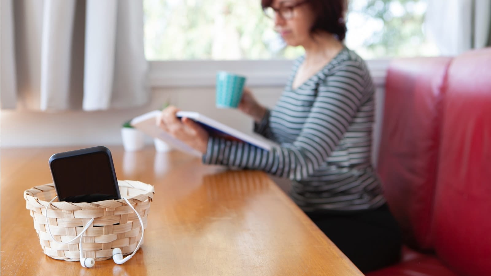 Dec 25 blog Woman reading book with phone put away