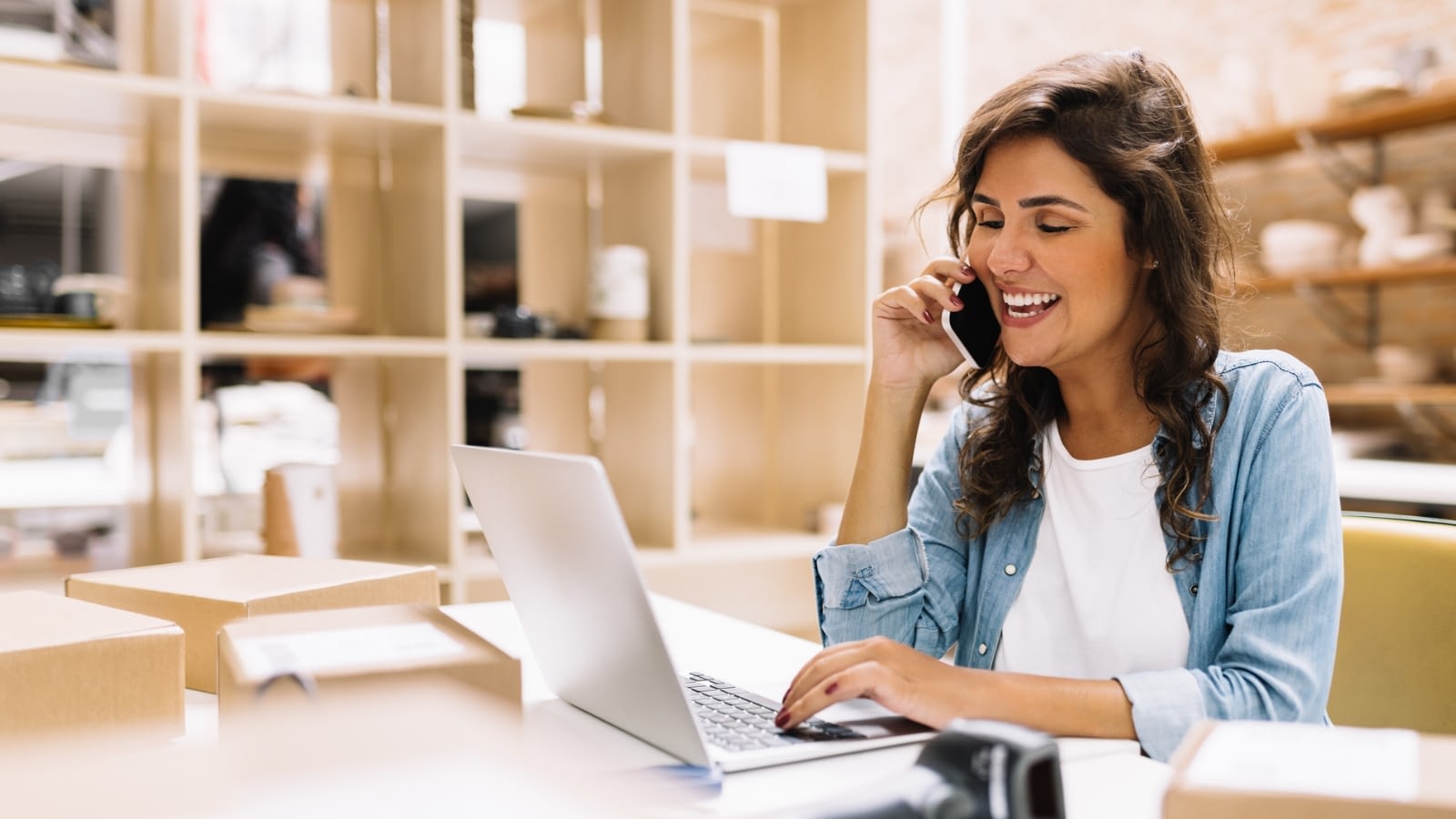 businesswoman on a call and working on laptop