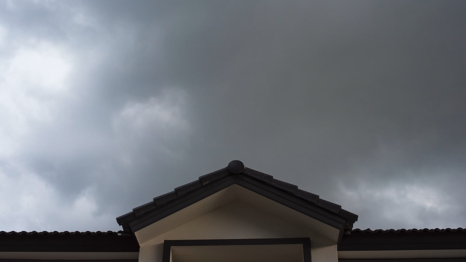 storm cloud gathering over closeup of house