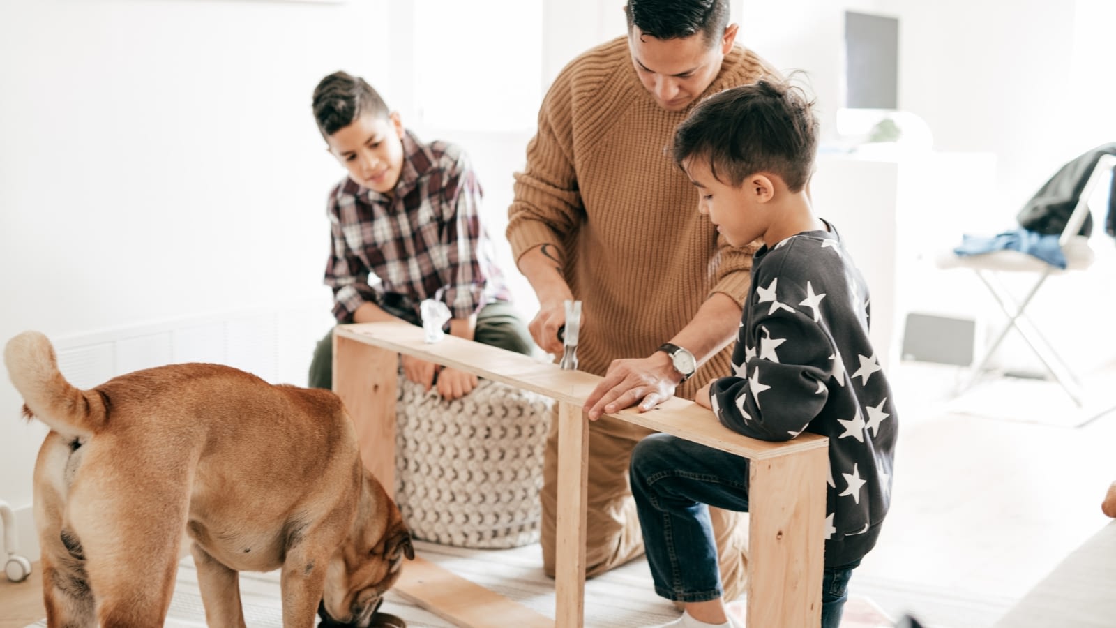 father and sons working on home project