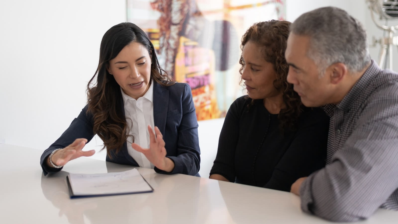 June 22 blog Couple speaking with their insurance agent about term versus whole life insurance.