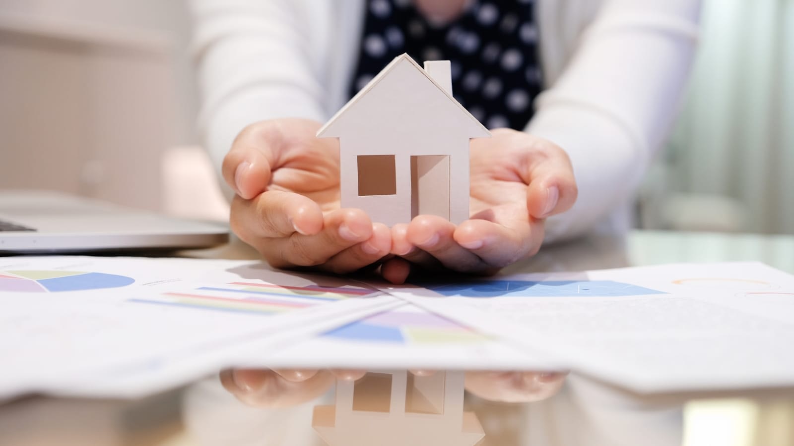 Woman holding model house