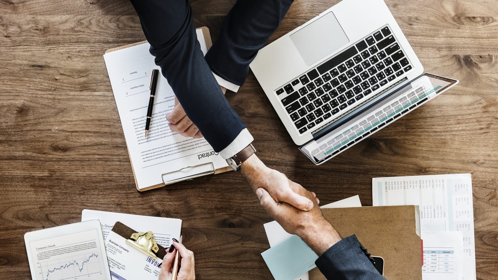 Insurance agent shaking a client's hand