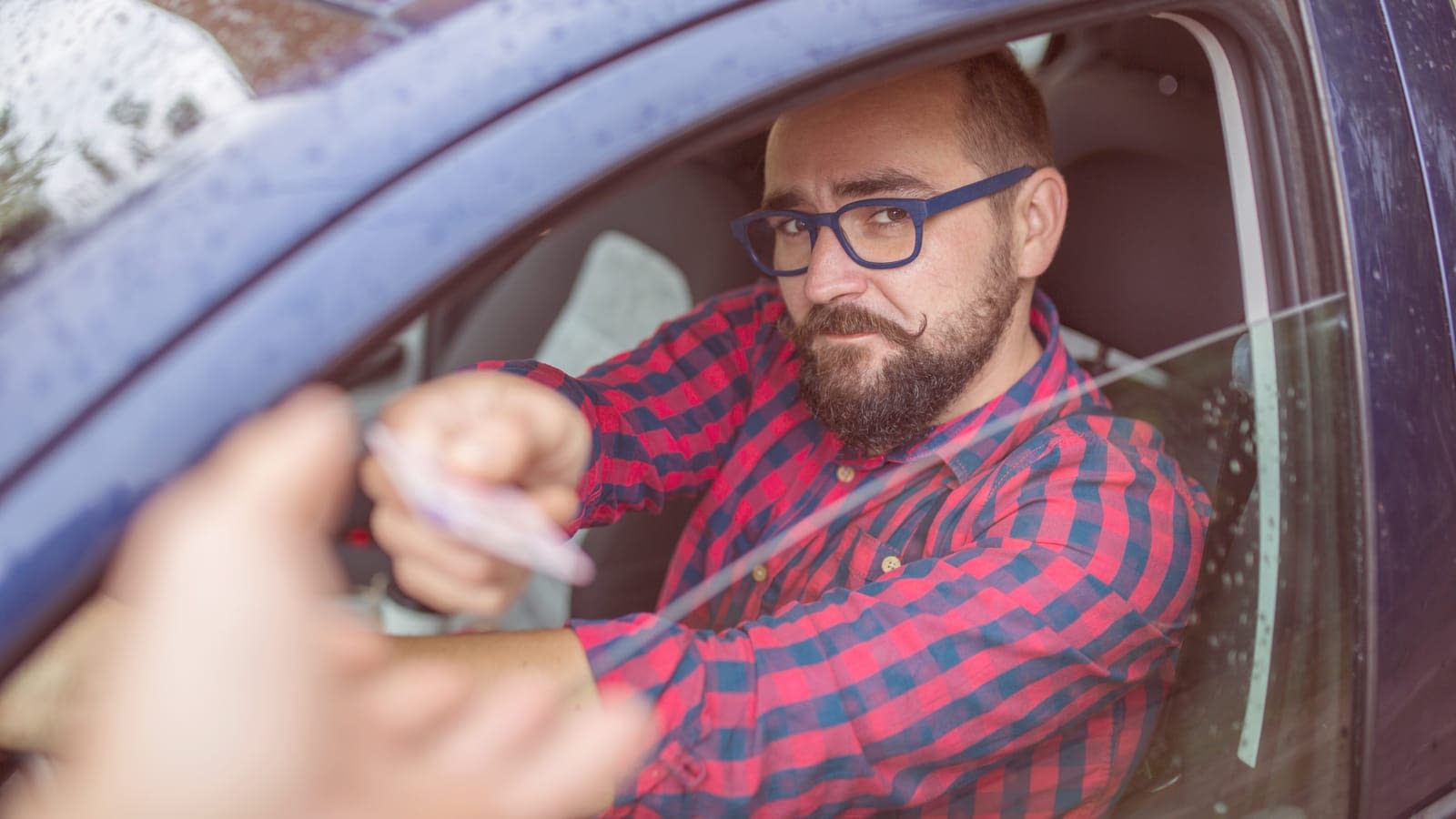License Verification Driver handing his license to a cop