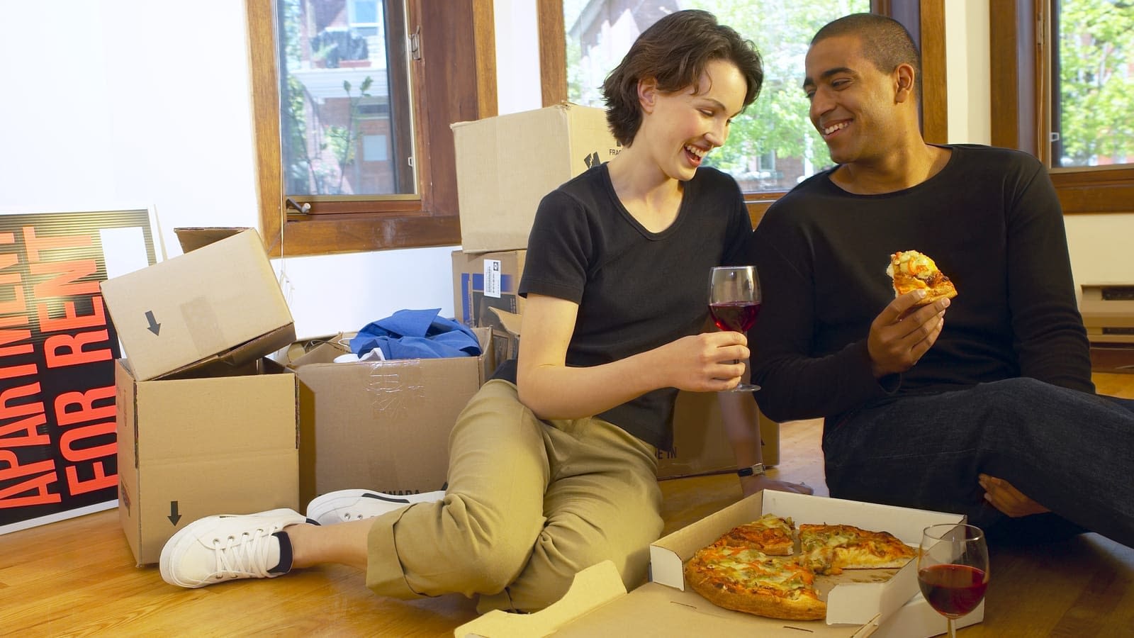New Apartment Renters Couple eating dinner in a new apartment