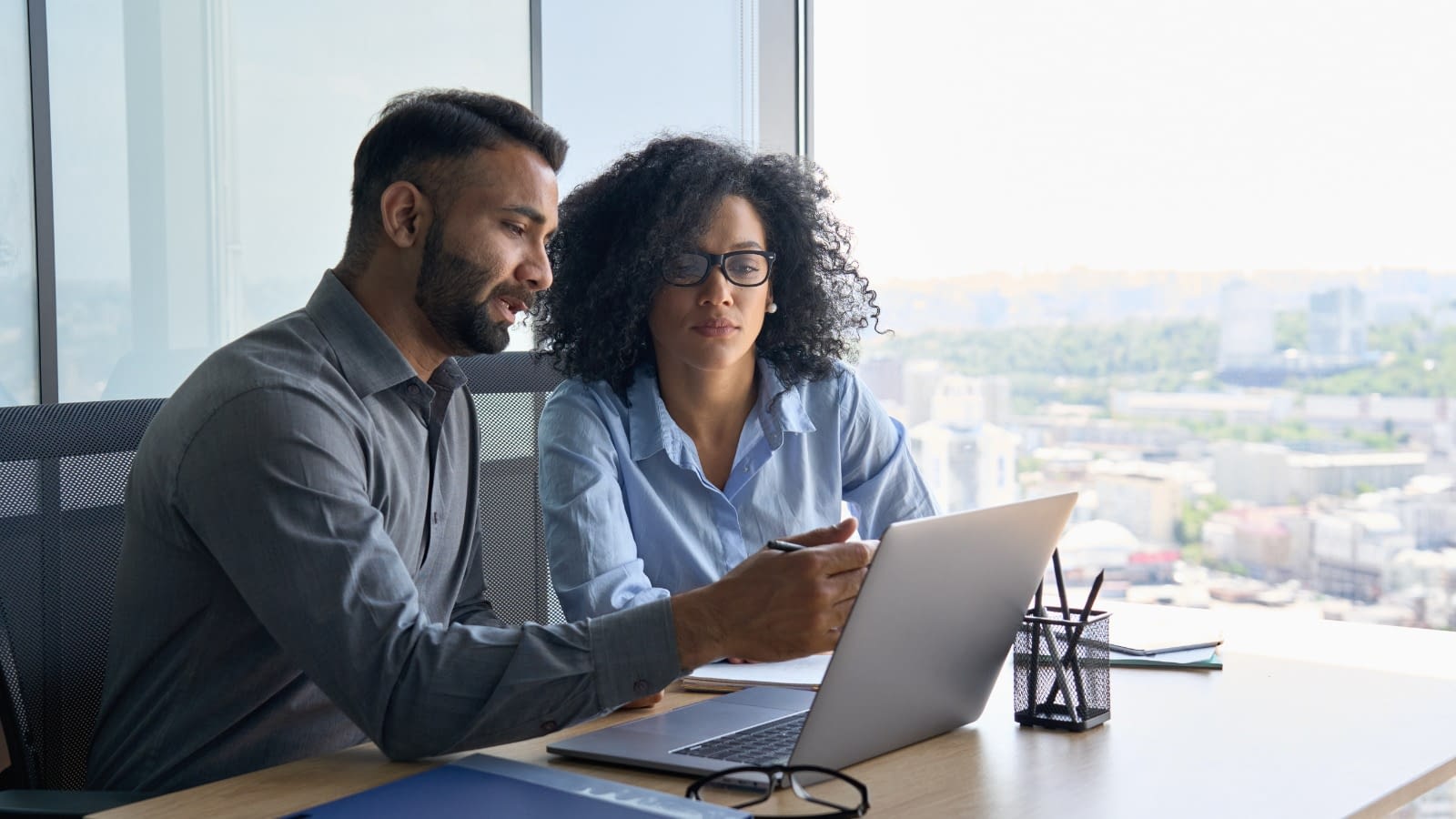 Business partners working together Two people looking at the computer
