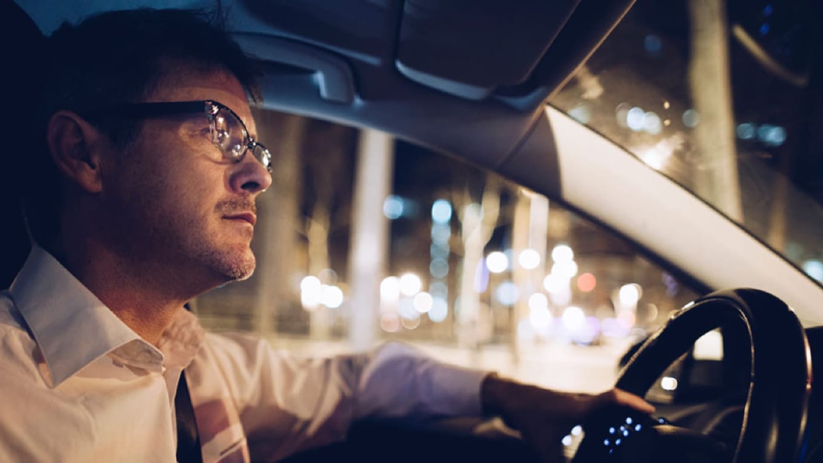 Man driving a car at night