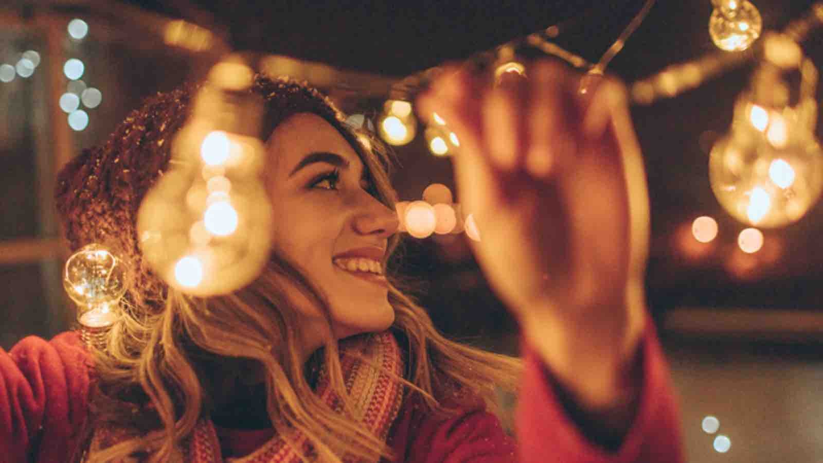 Woman hanging Christmas lights