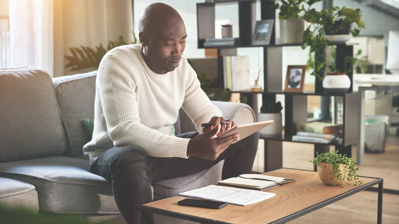 Mar 2 blog African-American man reading on iPad.