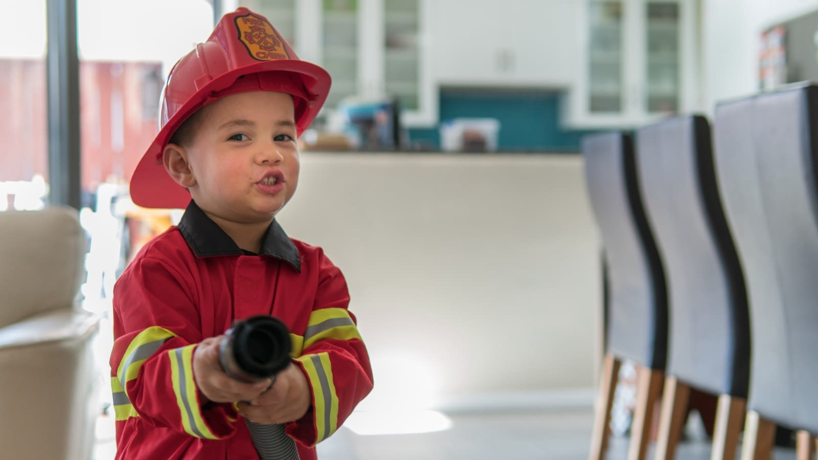 Oct 2 blog little boy dressed as firefighter in home