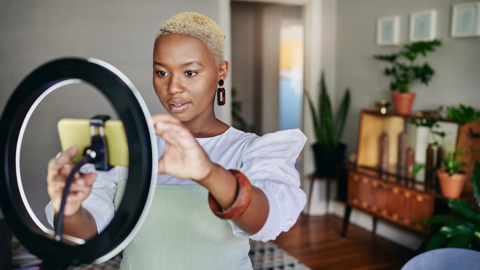 side gig woman preparing to record a video on phone