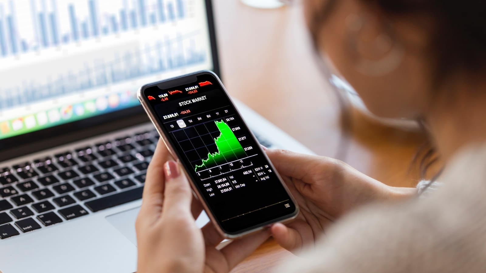 employee stock woman checking the stock market on her phone