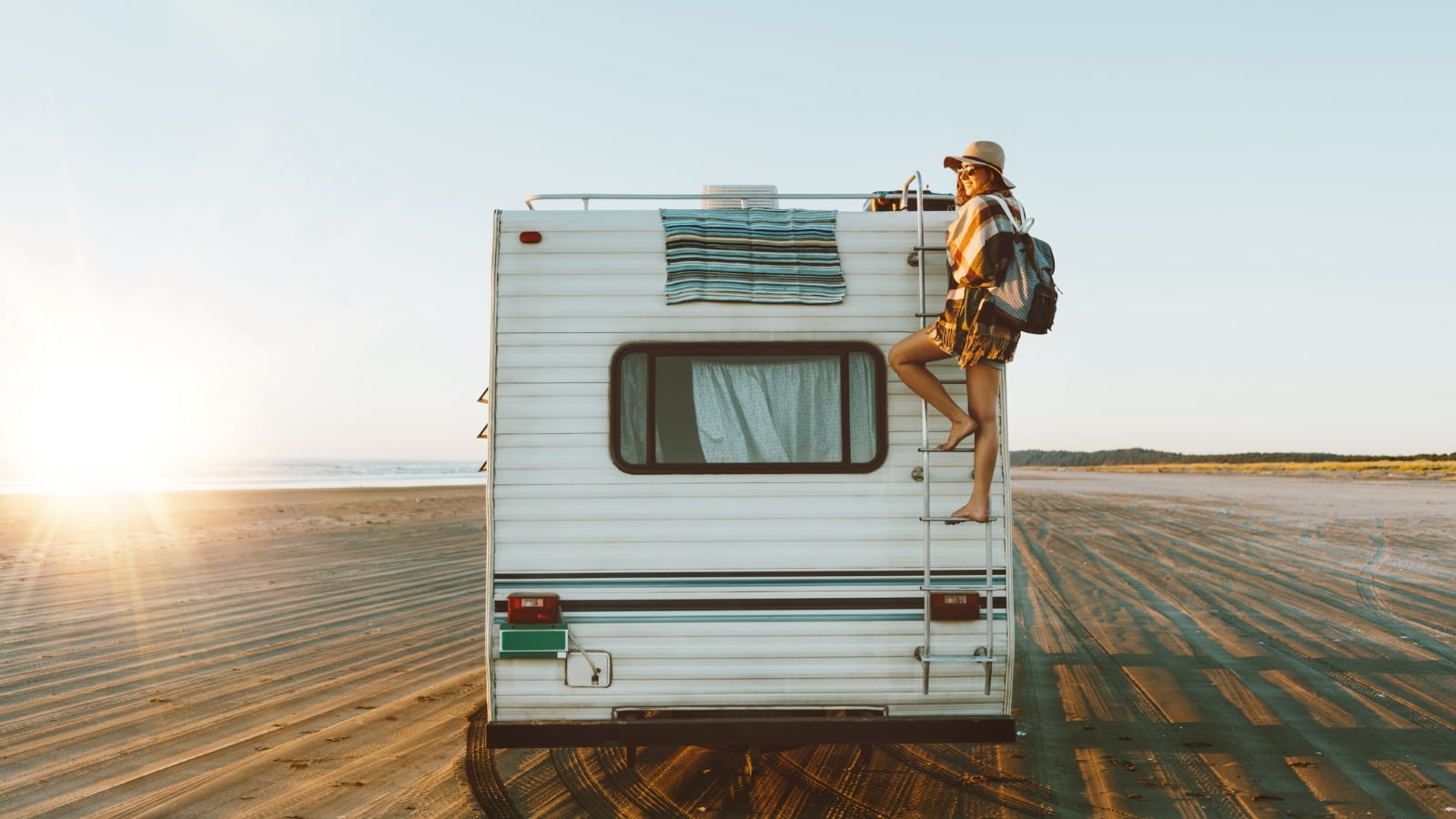 July 1 blog Woman climbing back of RV