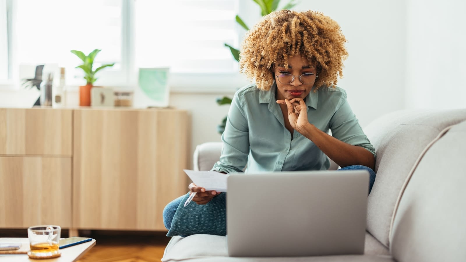 April 10 blog Young African-American woman reading on her laptop.