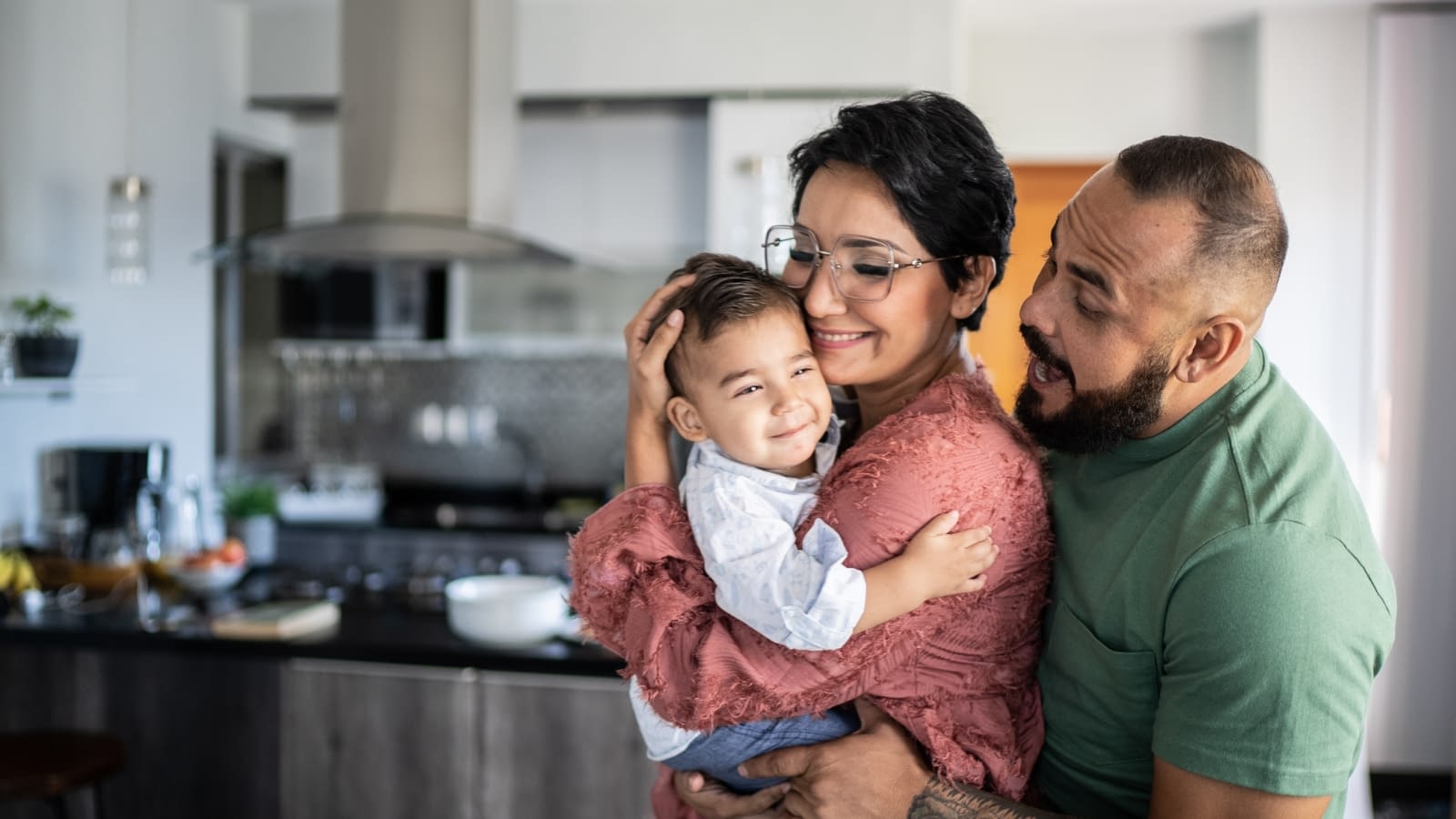 October 22nd Blog Featured Image Young hispanic couple holding baby in house and smiling