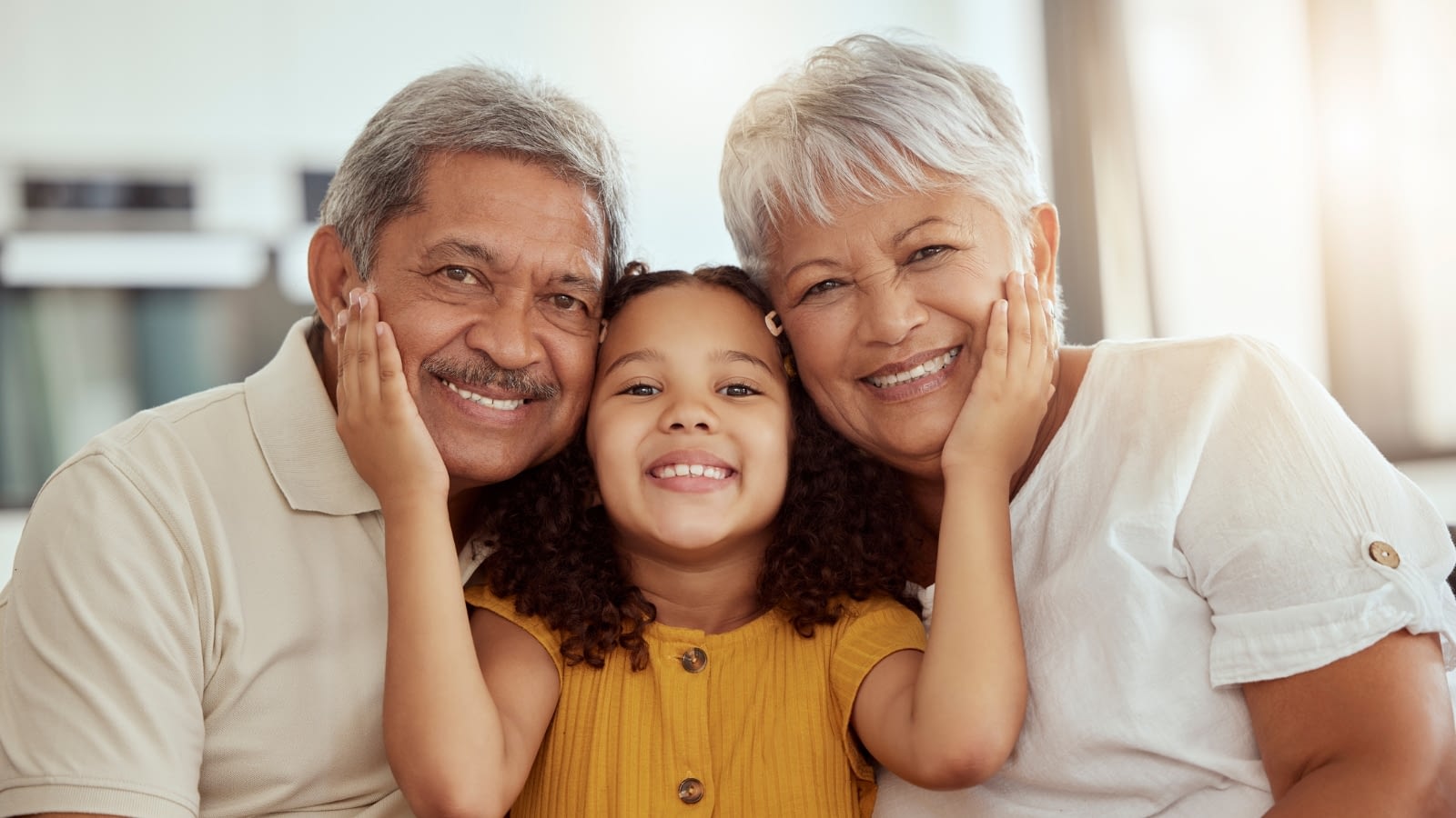 latina granddaughter hugging grandparents