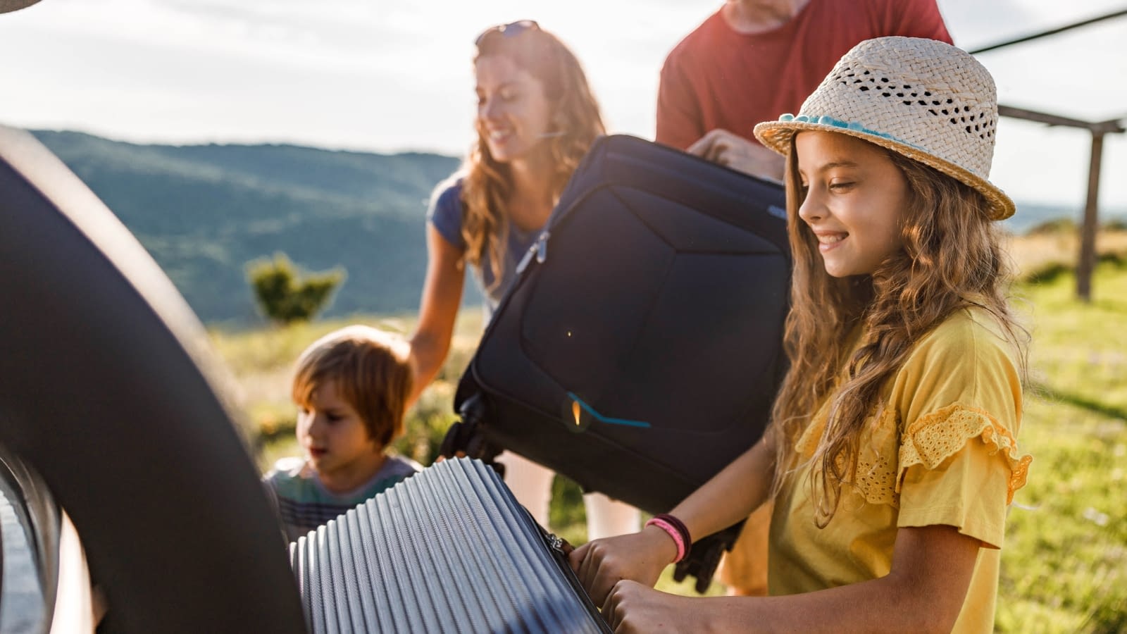 spring break family packing the car for vacation outside