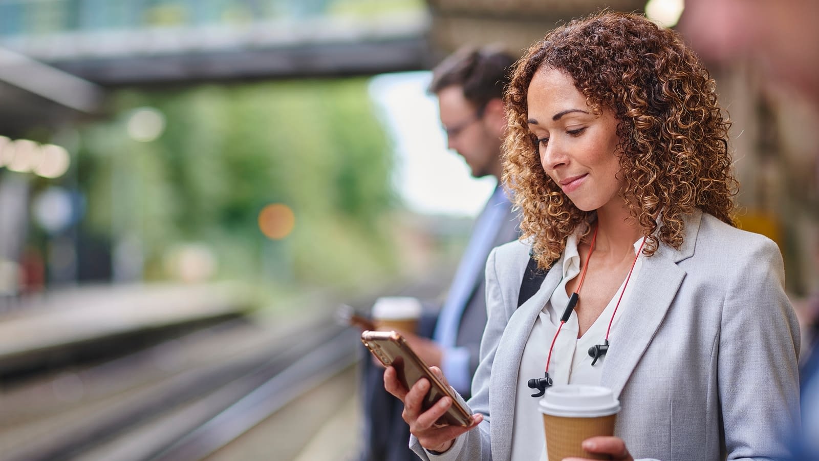 group benefits – fully vested businesswoman on phone with coffee