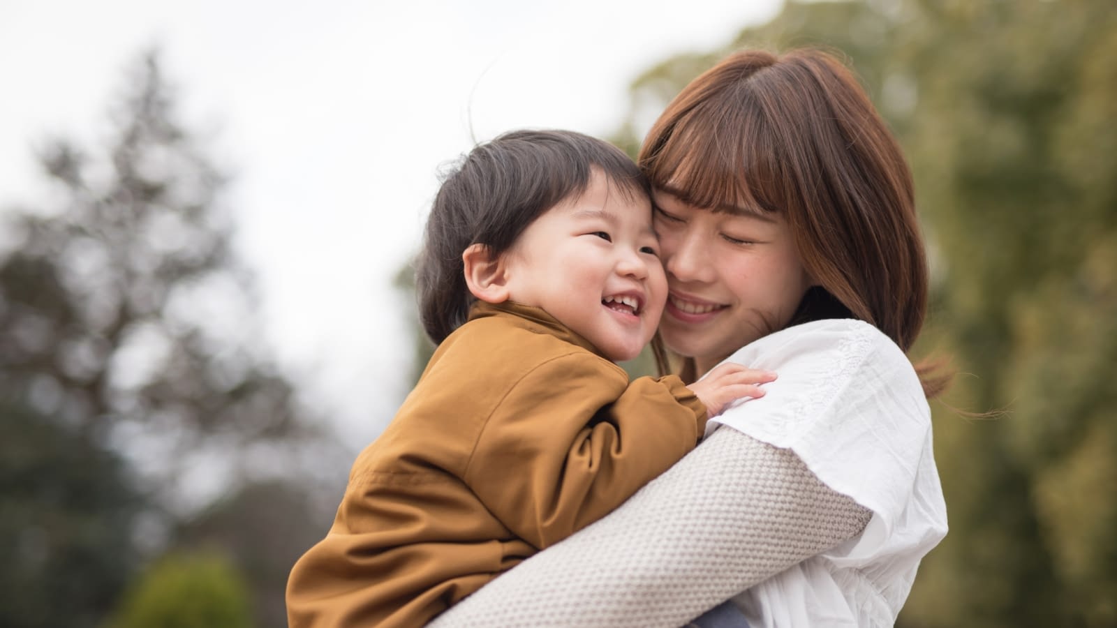child term riders mother and son embracing outside
