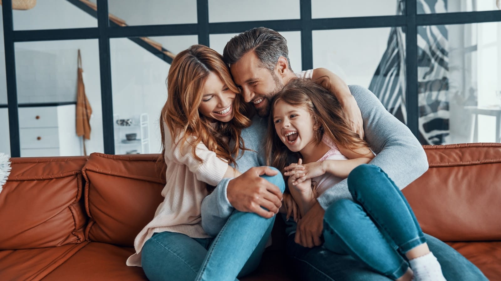 Young couple happy on the couch Happy family sitting together