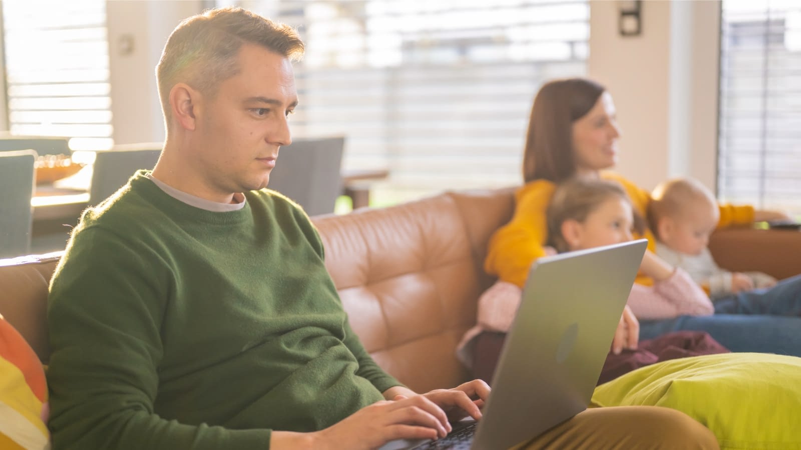 Jan 7 blog Man on lap top at home with wife and kids