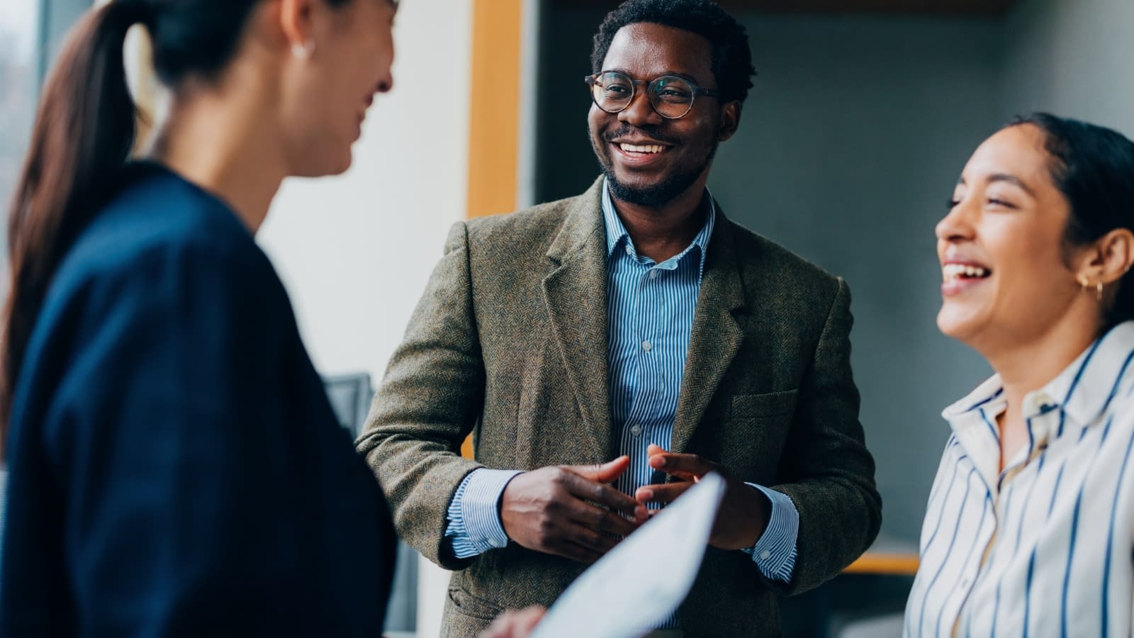 Dec 13 blog Group of employees talking at work